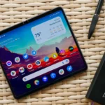 Google Pixel Fold trên bàn cạnh sổ tay, thể hiện tính năng làm việc.