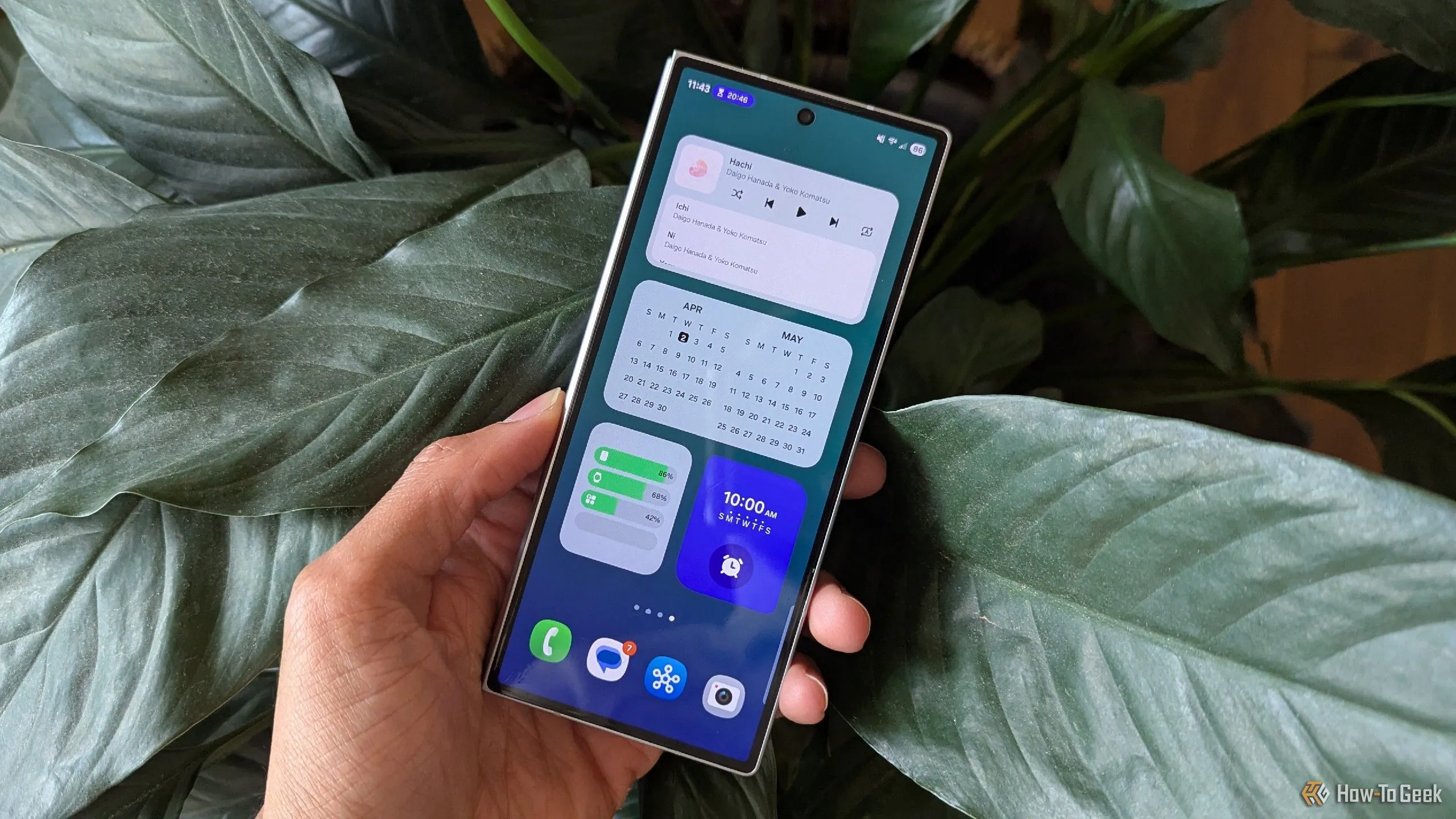 Màn hình chính One UI 7 trên màn hình phụ của Samsung Galaxy Z Fold 6, hiển thị các widget và icon trên nền mờ ảo.