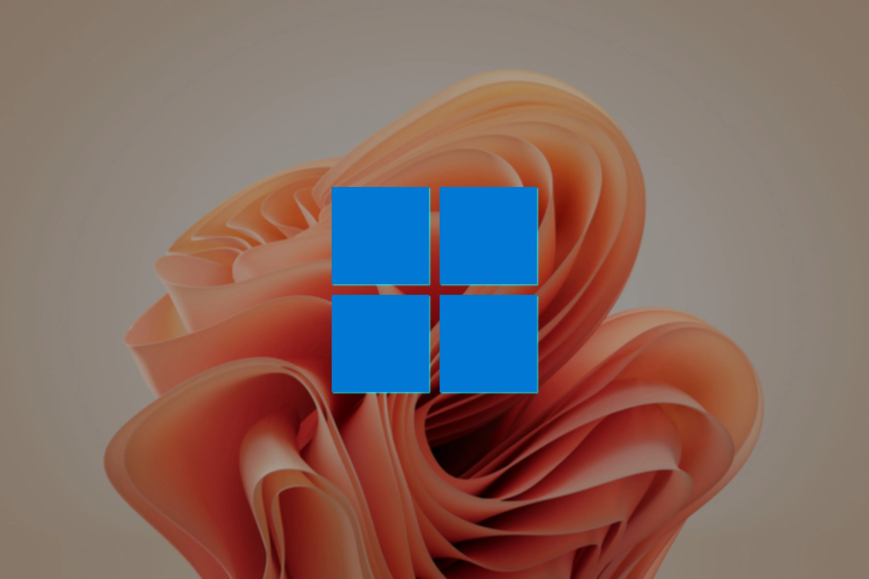 Biểu tượng Windows 11 nổi bật trên nền hình nền Bloom, nhấn mạnh tầm quan trọng của việc lựa chọn phiên bản Windows phù hợp và cấp phép hợp lệ khi tạo ISO tùy chỉnh.