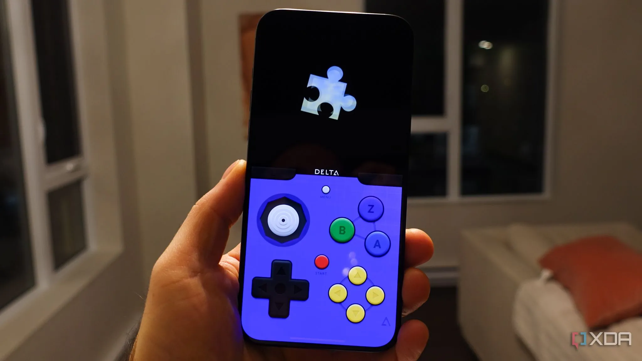 Điện thoại iPhone hiển thị giao diện ứng dụng Delta Emulator đang chơi game Super Mario Advance 4