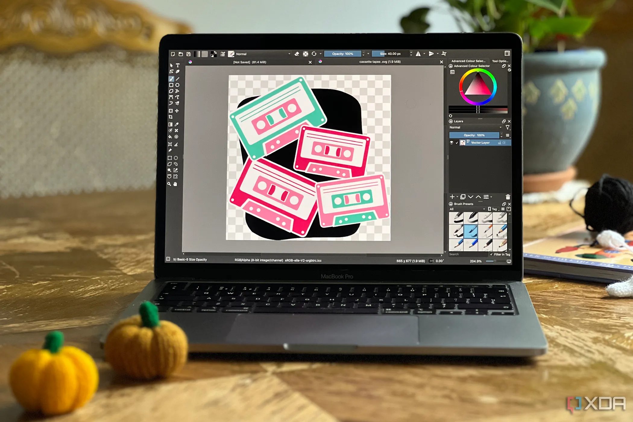 Krita vector trên MacBook laptop đặt trên bàn gỗ với các vật trang trí đan lát xung quanh