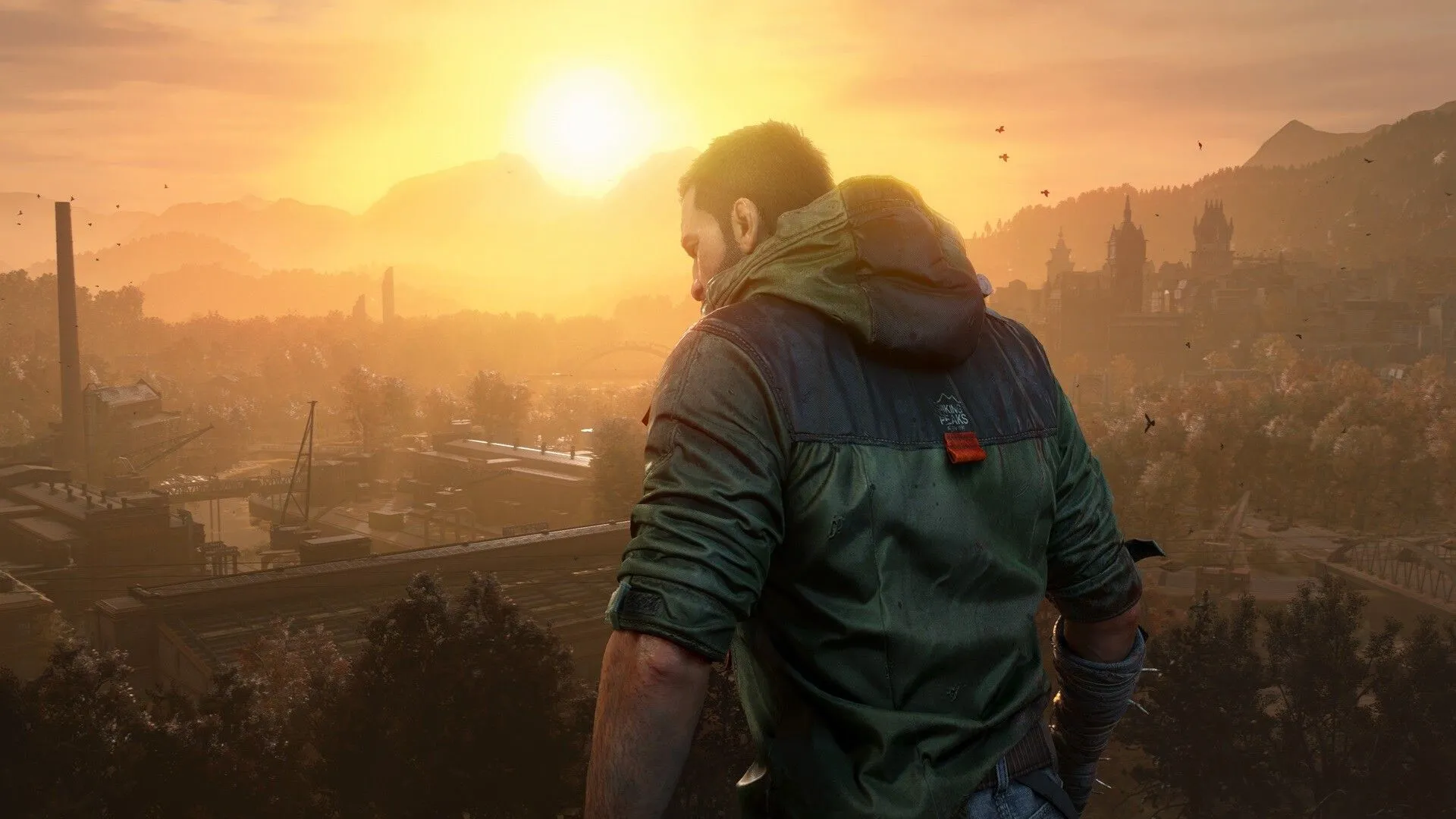 Kyle Crane, nhân vật chính của Dying Light: The Beast, đứng trên đỉnh tòa nhà nhìn về phía chân trời, thể hiện sự cô đơn và quyết tâm trong thế giới hậu tận thế