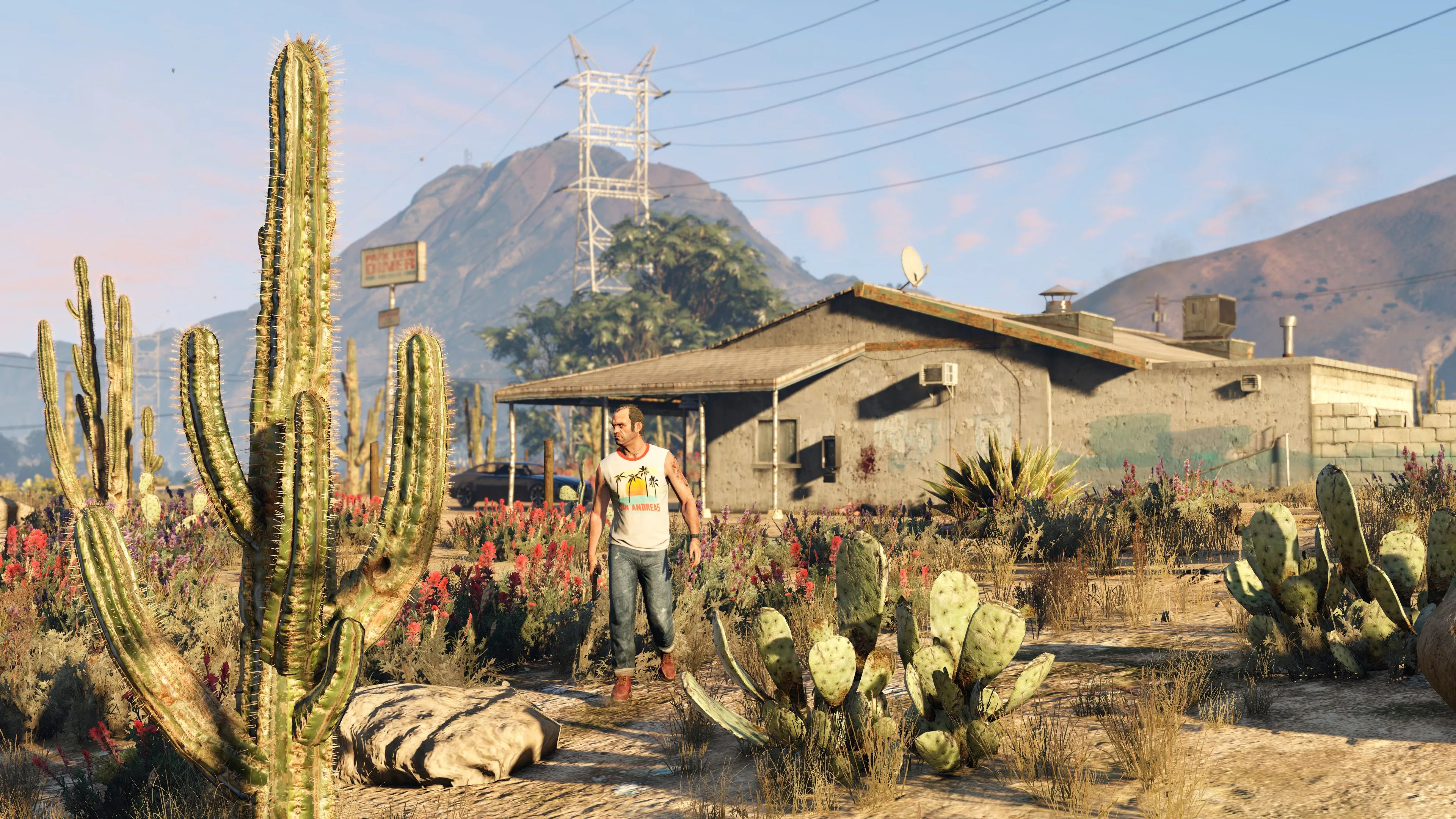 Nhân vật Trevor Philips trong Grand Theft Auto V đi dạo trước một ngôi nhà ở Blaine County, biểu tượng cho chiều sâu cốt truyện game
