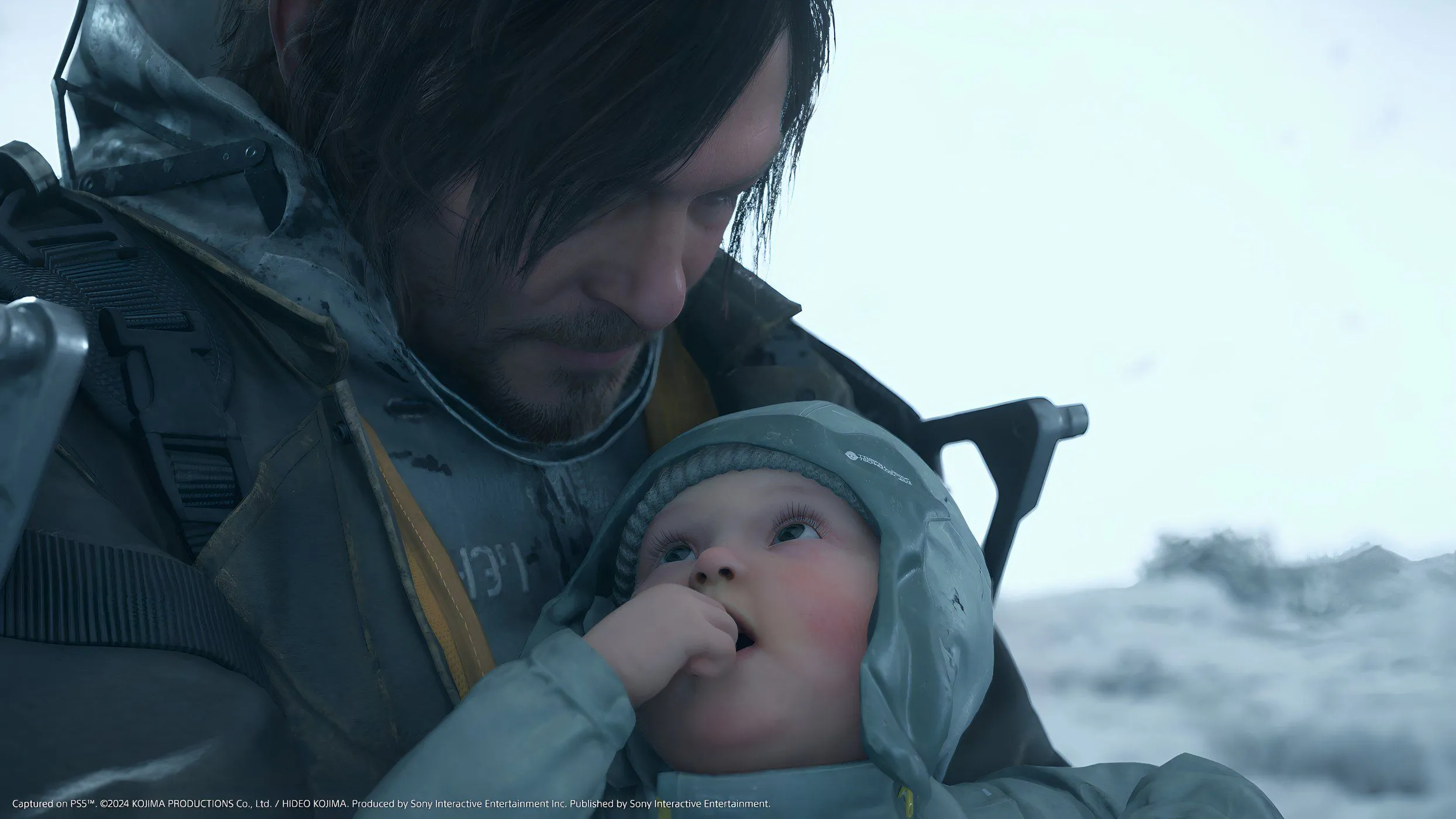 Sam Porter Bridges và BB trong Death Stranding 2: On The Beach, giữa một khung cảnh hoang tàn