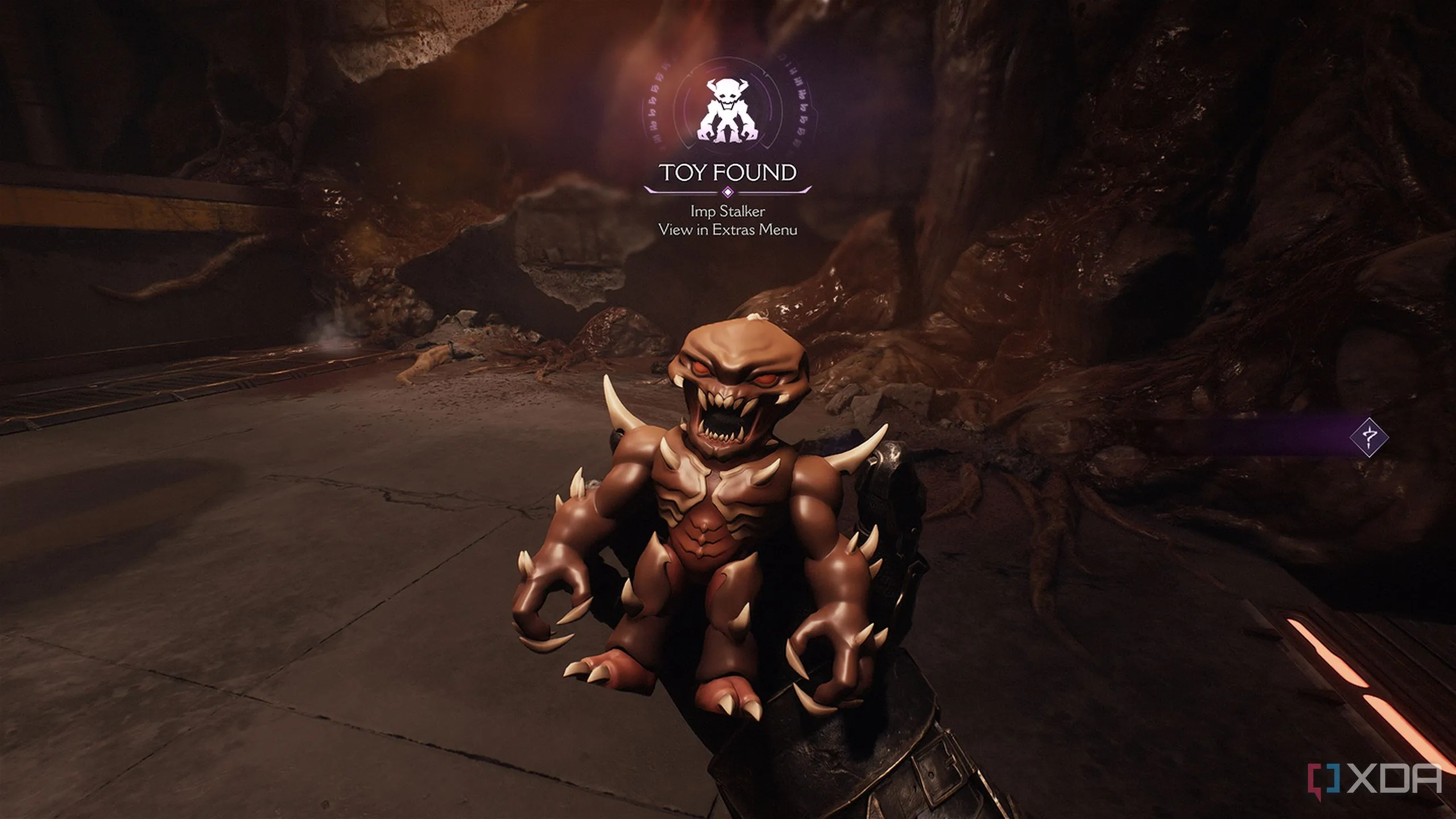 Vật phẩm sưu tầm Đồ Chơi Imp Stalker nằm trên nền đất trong Doom The Dark Ages